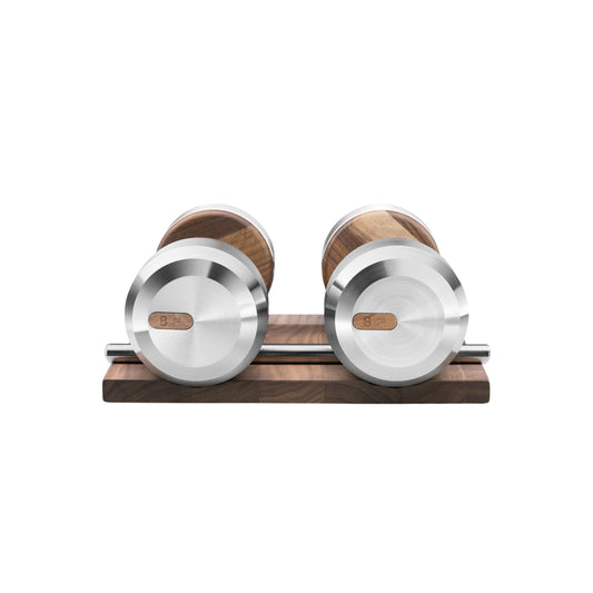 Front view of the luxury dumbbells made with natural walnut wood and stainless steel on natural walnut wooden stand. Available in weights ranging between 2 - 30kg. PENT. COLMIA - Luxury Dumbbells on Wooden Stand