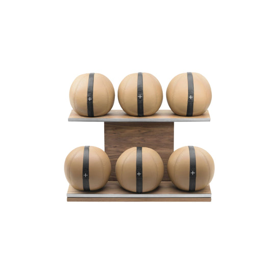 Six brown leather medicine balls with black accent leather, arranged on two shelves made of natural walnut wood. PENT. MOXA Set Ultimate - Set of 6 Medicine Balls on Horizontal Wooden Stand