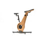 A modern exercise bike with a wooden frame and minimalist design, featuring an adjustable seat and streamlined structure. NOHRD Bike V2