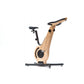 A modern exercise bike with a wooden frame and minimalist design, featuring an adjustable seat and streamlined structure. NOHRD Bike V2