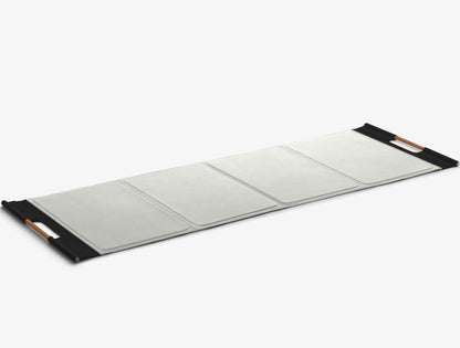 A luxurious exercise mat in white and black premium Italian leather, suitable for yoga or fitness workouts. PENT. MATA