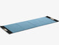 A luxurious exercise mat in blue and black premium Italian leather, suitable for yoga or fitness workouts. PENT. MATA